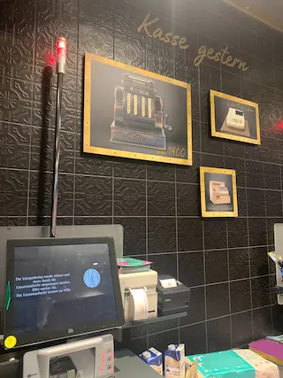 A self-checkout in a German supermarket. Images on the wall show old checkout systems, with the words above saying ‘Checkout yesterday’ Image: Private